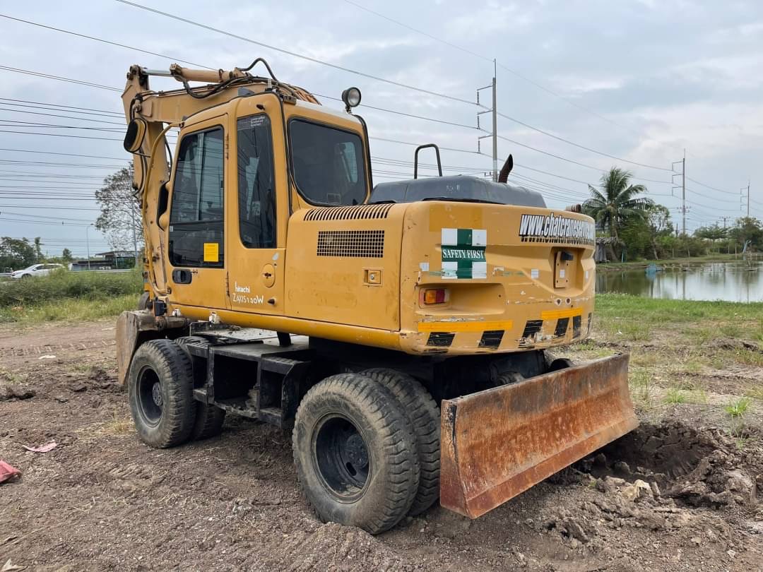 ขาย 1,180,000 รถแบคโฮล้อยาง HITACHI ZX130W ปี 2004