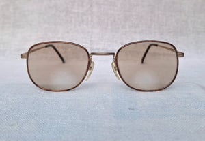 แว่นสายตาแฮนด์คราฟท์–ไบโฟคอลในตำนานศตวรรษที่ 20 จิออร์จิโอ วินเซนเต้–GIORGIO VINCENTE มือหนึ่ง ทศวรรษ 1990 กรอบไทเทเนียมบริสุทธิ์สีทอง โคตรเลนส์กระจกอังกฤษ 2 ชั้น BIVUE ของ ไวส์แมน–อัลก้า ค่าสายตายาว +275 มองไกล +50 ชัดแจ๋วถึงปลายฟ้า ใช้เป็นแว่นกันแดดได้ในตัว ขนาดมาตรฐาน–Standard One Size 138mm